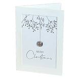 A white Christmas greeting card with a silver mistletoe hanging, a glass pebble bauble and the words 'MERRY Christmas' printed on the front.