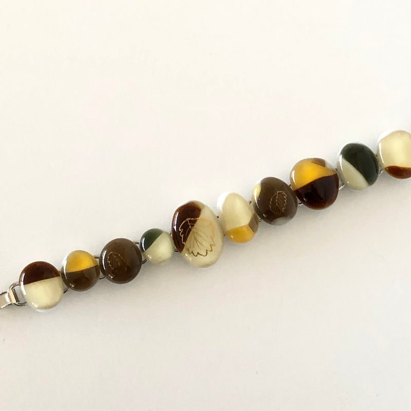 one-of-a-kind glass bracelet with gold decal