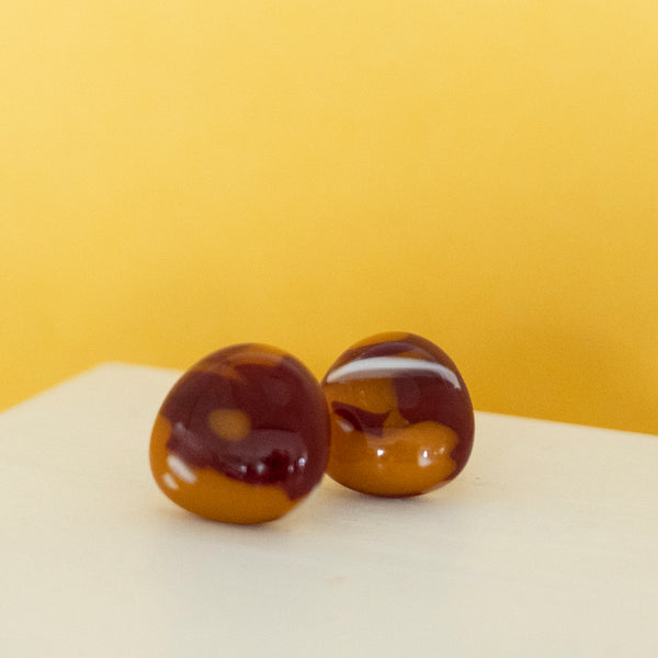 Fused glass studs, orange and red with delicate pattern